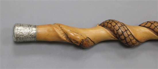 An Asian carved wooden serpent walking stick, 33in.